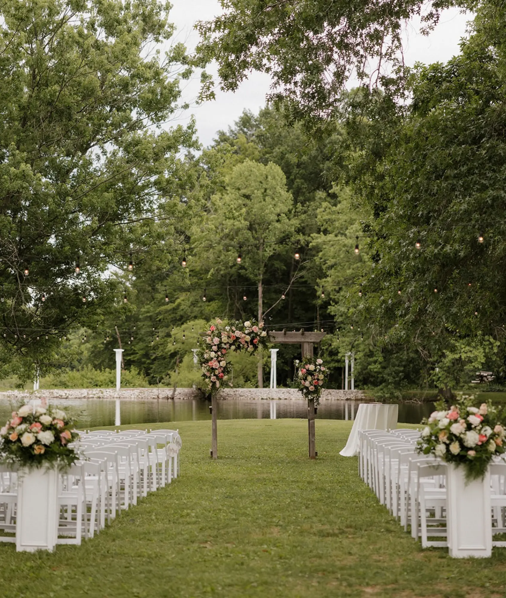 Lawn ceremony with string lights at Abram Farms