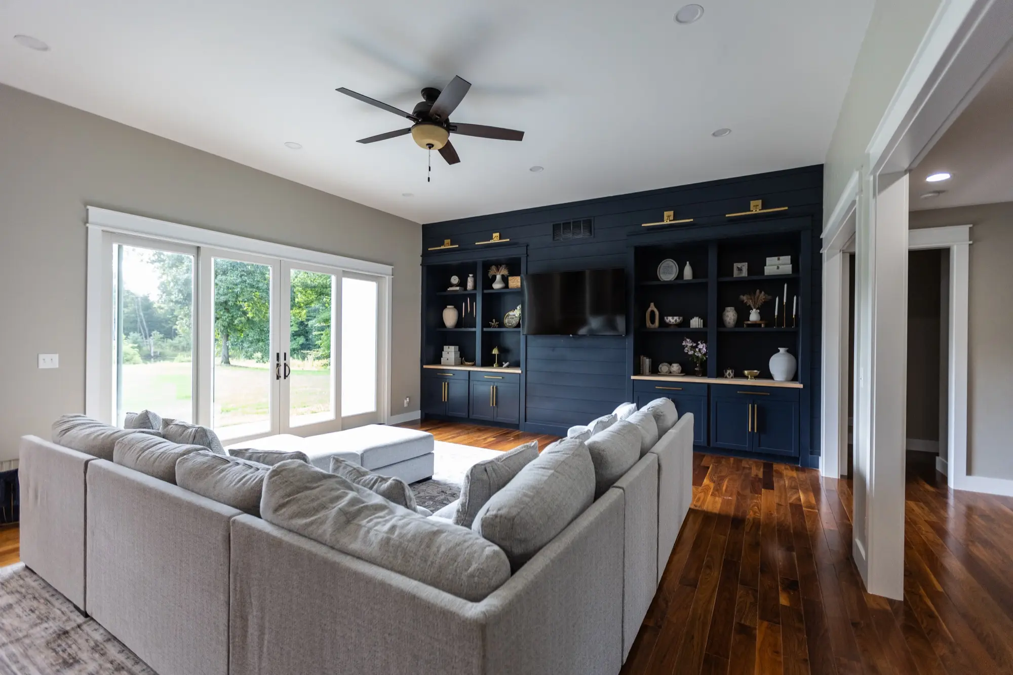 Living room at Lakeside Manor with sectional sofa and built-in shelving